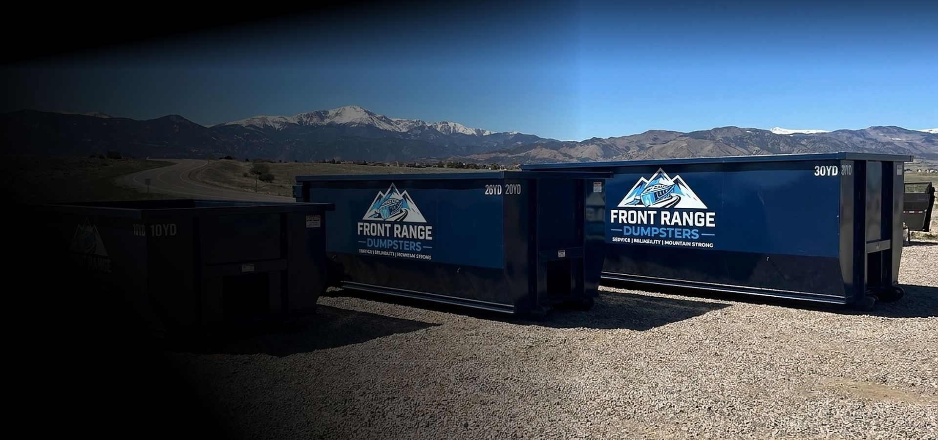 Front Range Dumpsters roll-off containers in 10, 20 and 30-yard sizes with snow-capped mountains behind